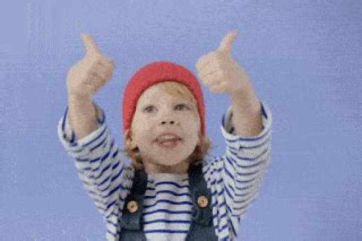 When can toddlers do thumbs up?